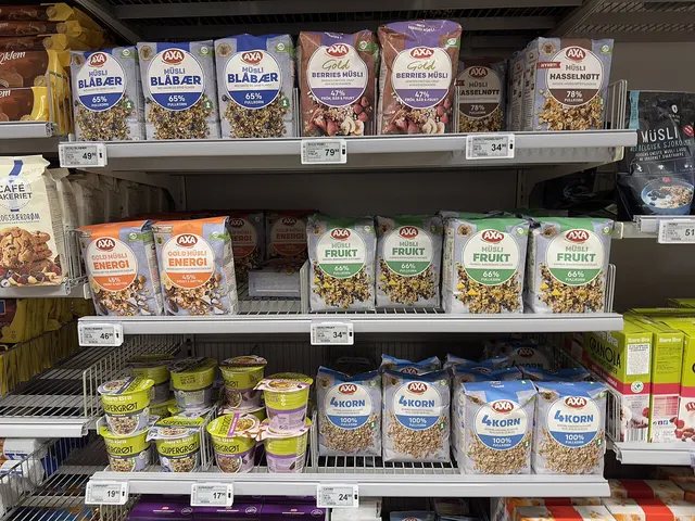 Photograph: Supermarket aisle with grocery shelves stocked with breakfast cereals.
